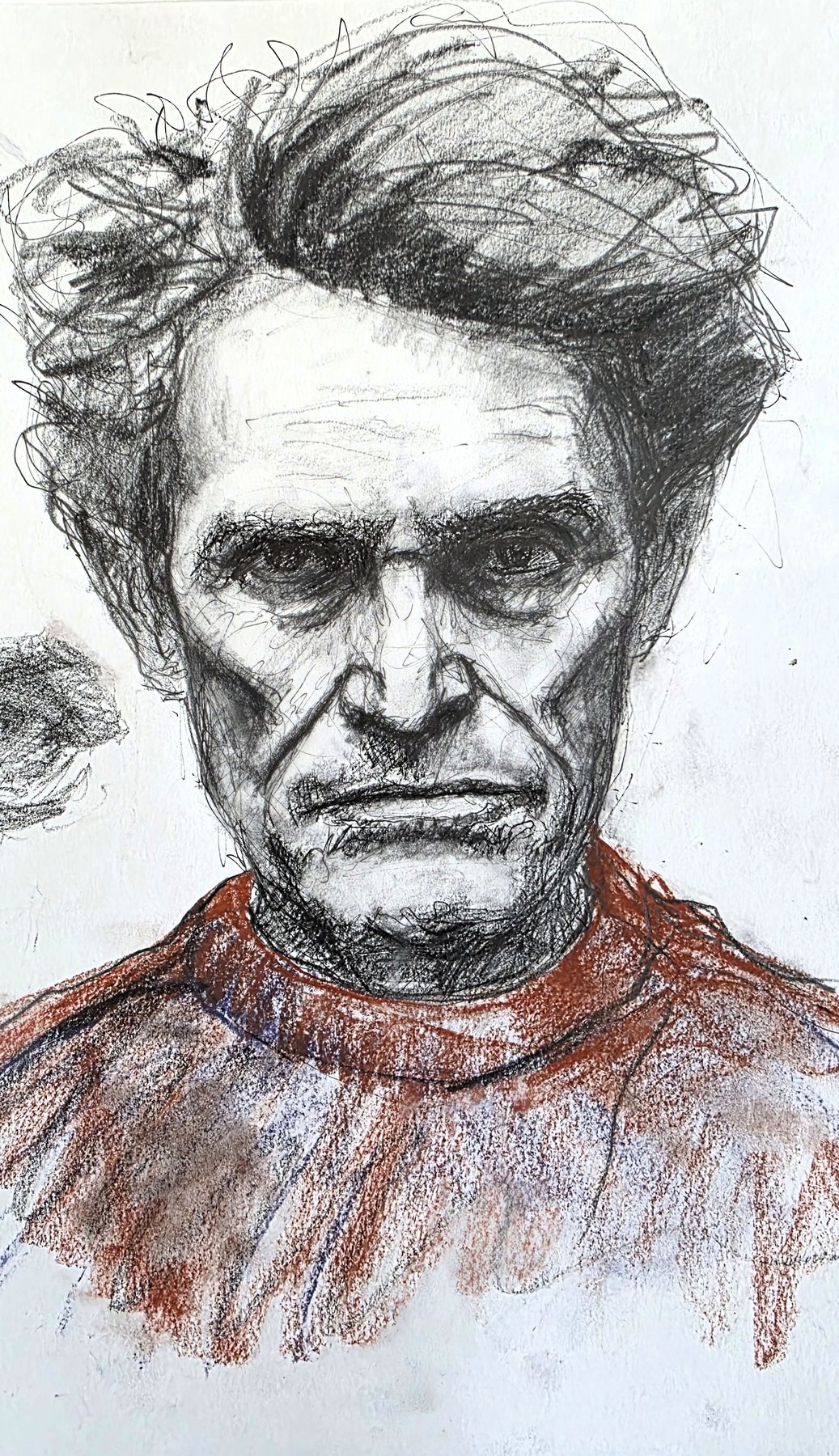 Pencil portrait of a gaunt man with swept-back hair, in a red sweater