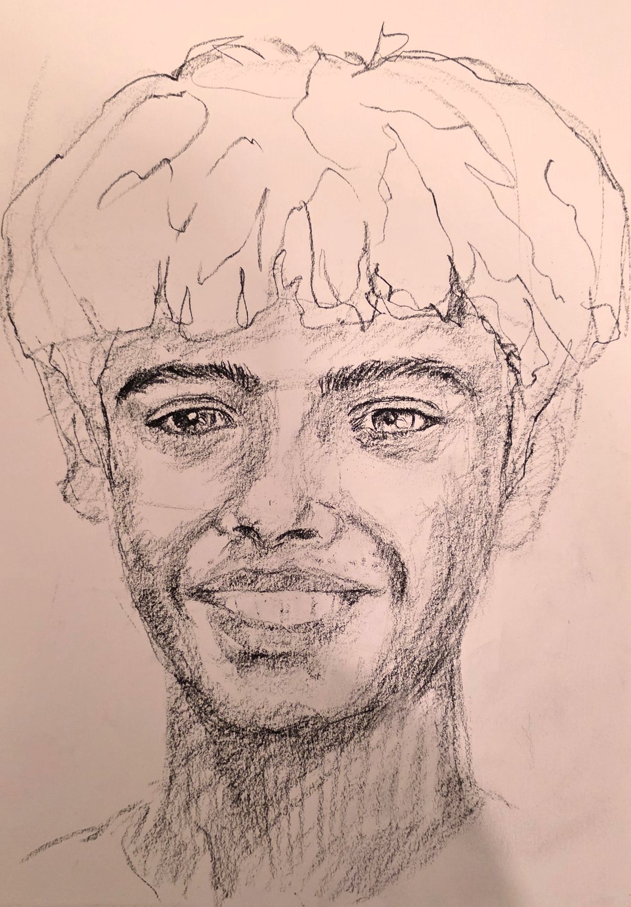Pencil portrait of a smiling young man with thick wavy hair