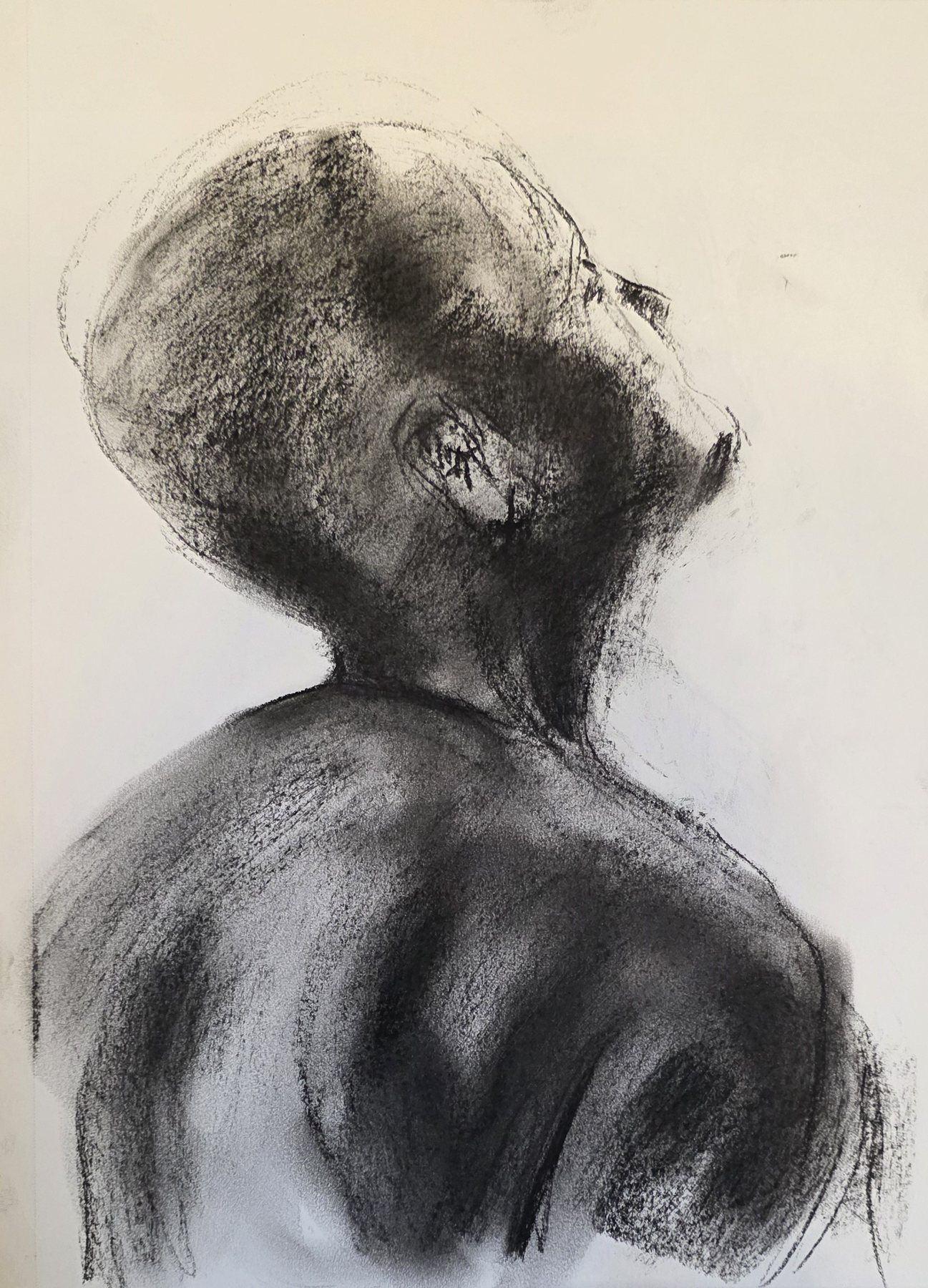 Charcoal study of a figure from behind, head tilted back